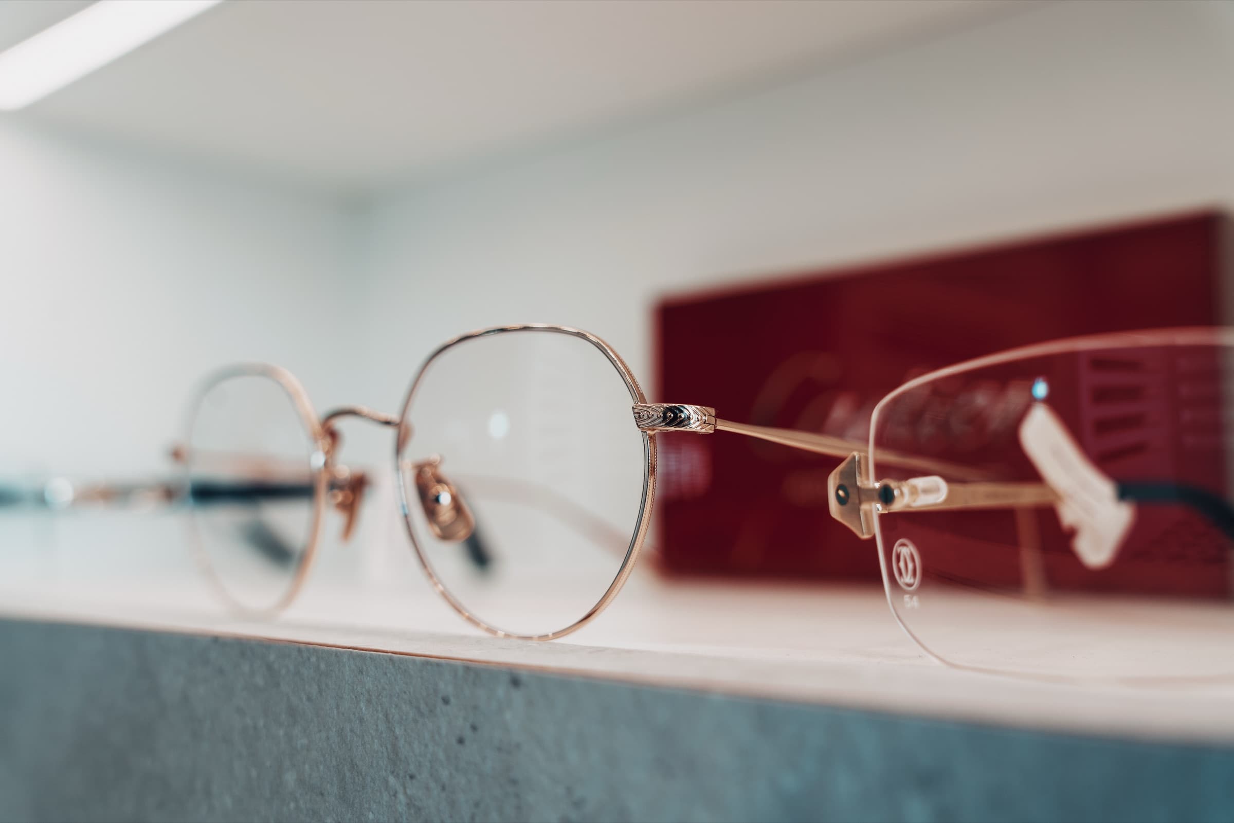 Close-up detail of rose gold rimless frame and Cartier display